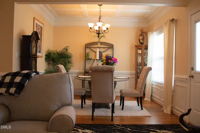a view of a dining room with furniture and a chandelier
