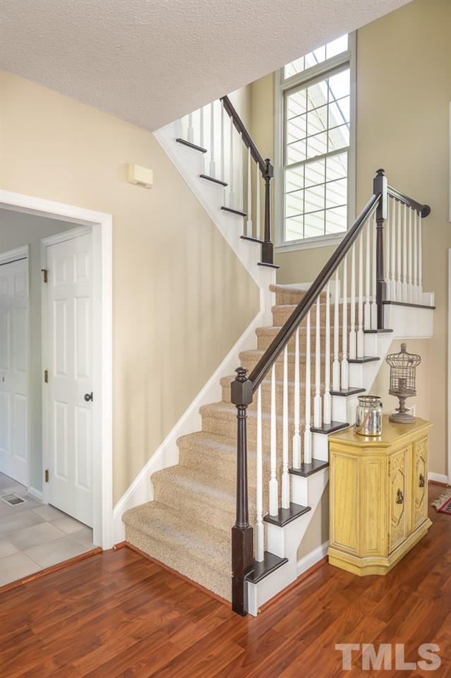 5608 Edgebury Road Raleigh, NC 27613 - Photo 3 of 11 a view of staircase with wooden floor and fan