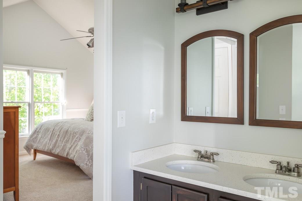 5608 Edgebury Road Raleigh, NC 27613 - Photo 9 of 11 a en suite bathroom with a sink and a mirror