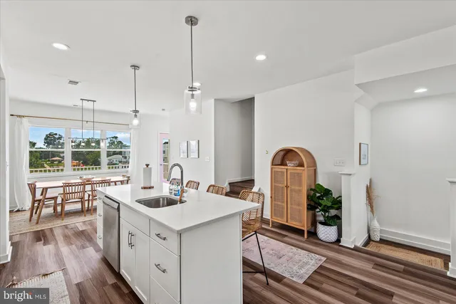 a large kitchen with lots of counter space a sink appliances and cabinets