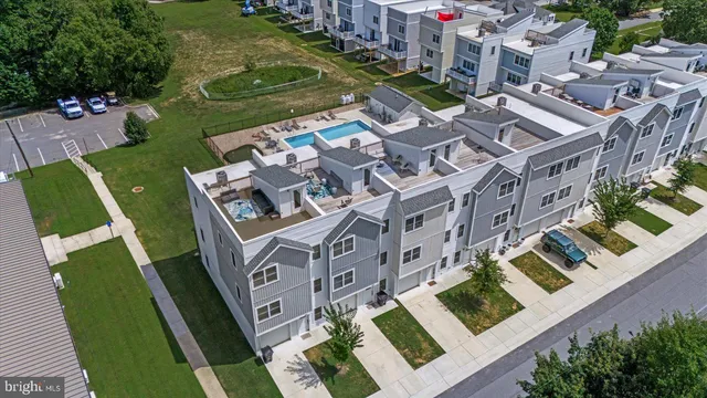 an aerial view of lake residential houses with outdoor space and swimming pool