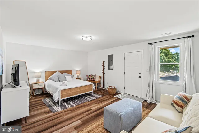 a bedroom with furniture and a book shelf