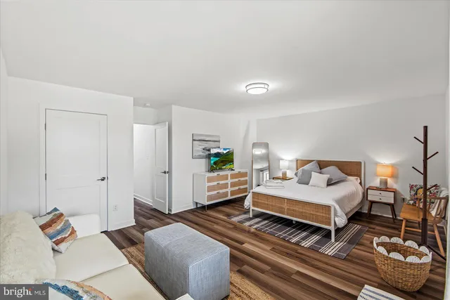 a bedroom with furniture and a flat screen tv