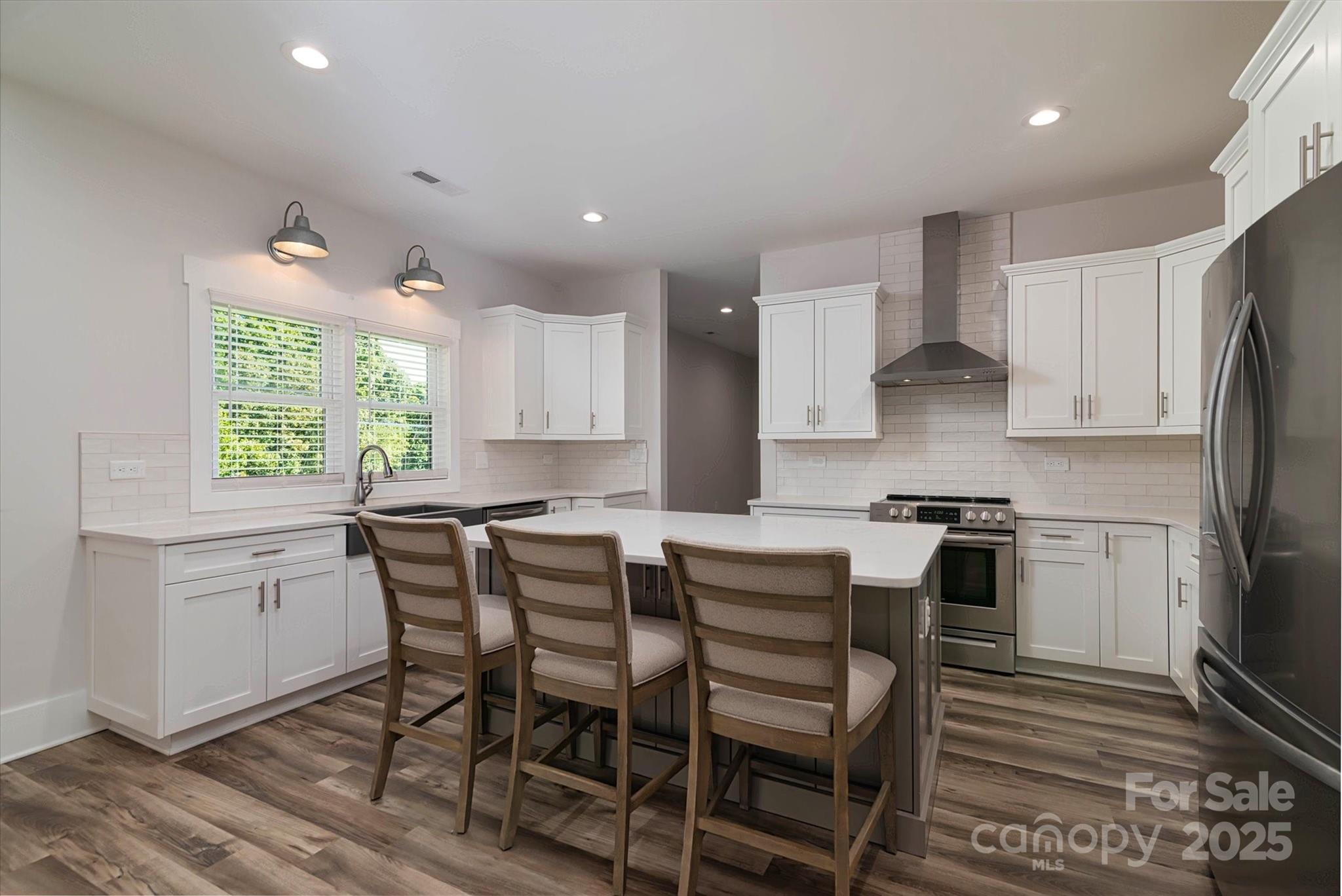 5345 Christopher Road Iron Station, NC 28080 - Photo 14 of 48 a kitchen with stainless steel appliances kitchen island granite countertop a table chairs sink and cabinets
