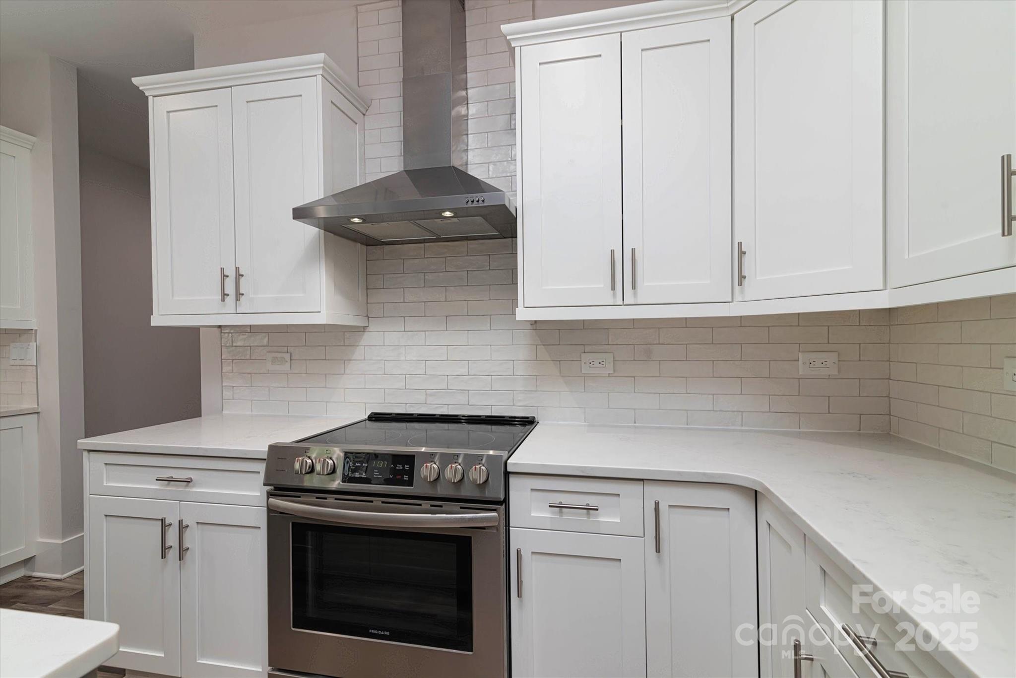 5345 Christopher Road Iron Station, NC 28080 - Photo 17 of 48 a kitchen with granite countertop white cabinets and stainless steel appliances
