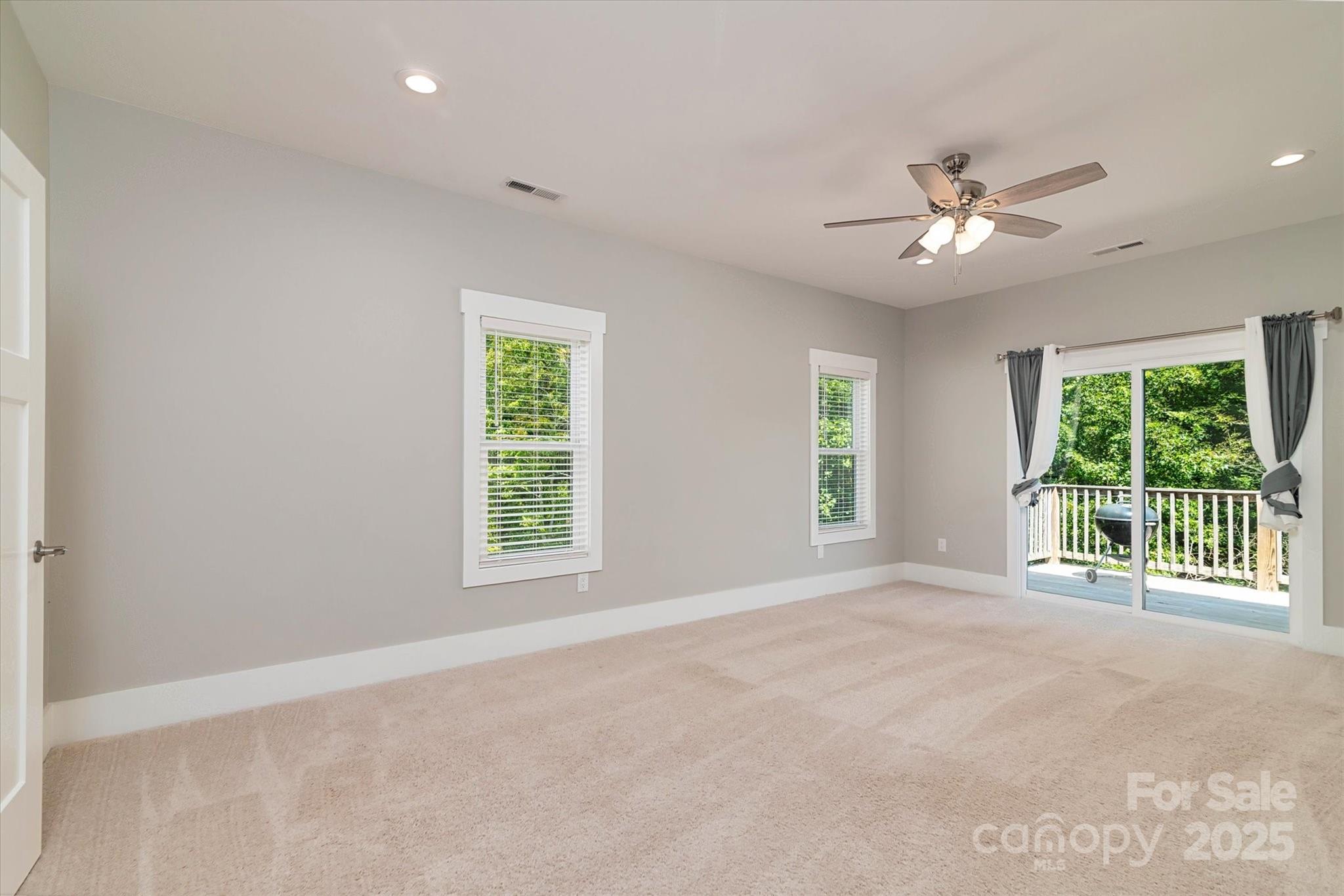 5345 Christopher Road Iron Station, NC 28080 - Photo 24 of 48 an empty room with windows and ceiling fan