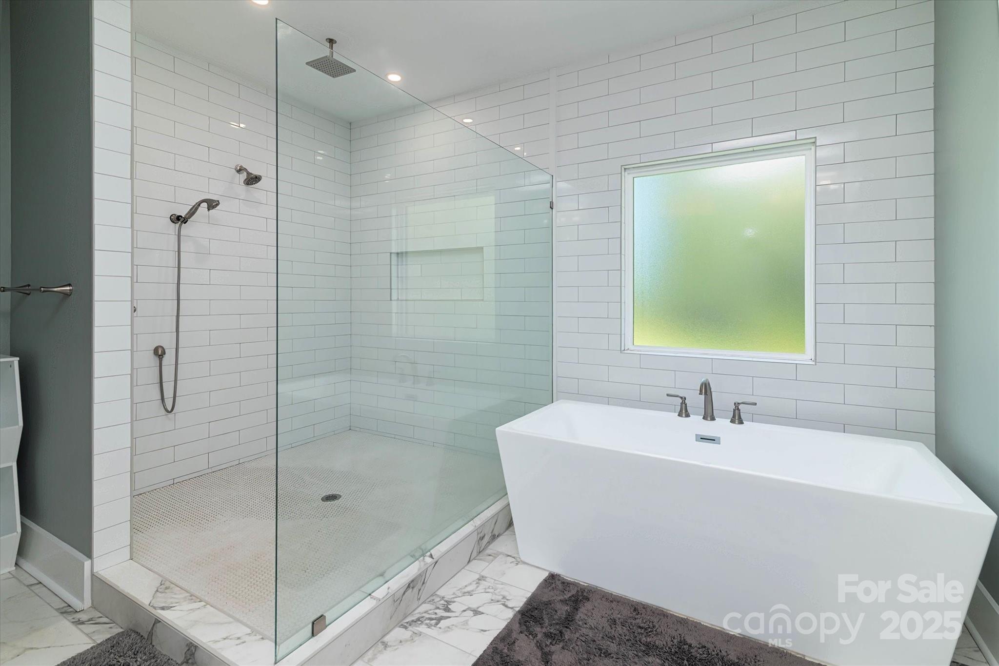 5345 Christopher Road Iron Station, NC 28080 - Photo 29 of 48 a bathroom with a bathtub and a shower
