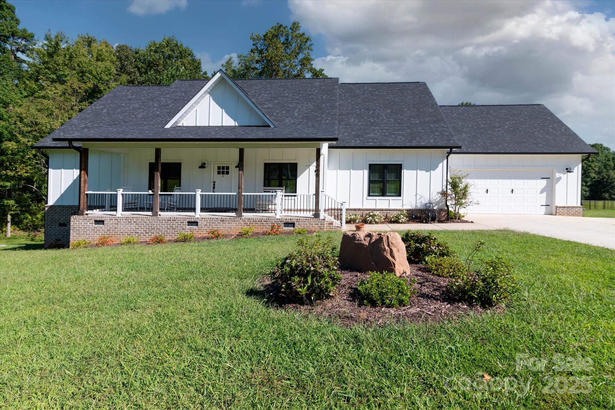 5345 Christopher Road Iron Station, NC 28080 - Photo 3 of 48 a front view of house with yard and outdoor seating