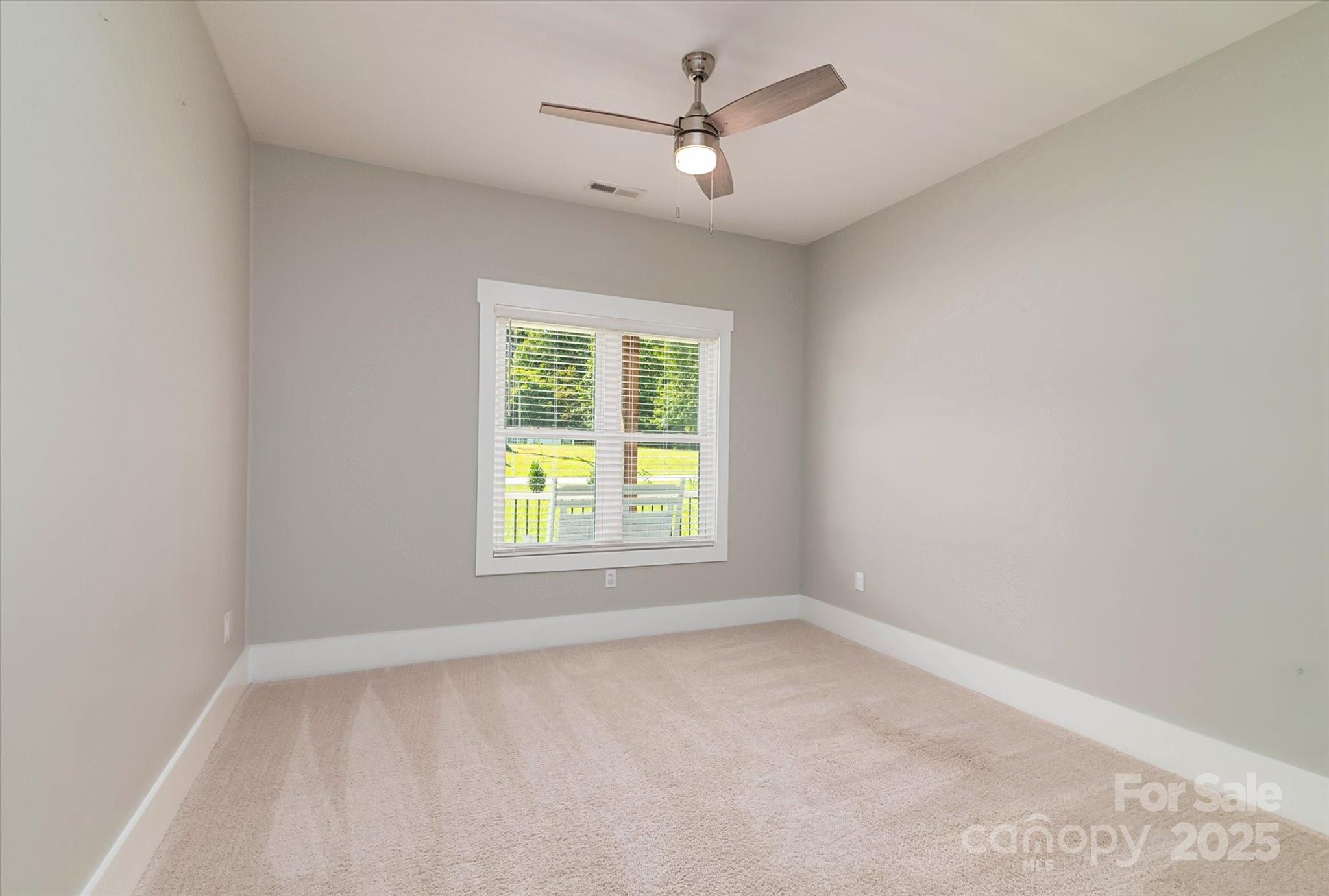 5345 Christopher Road Iron Station, NC 28080 - Photo 34 of 48 an empty room with a window and a ceiling fan