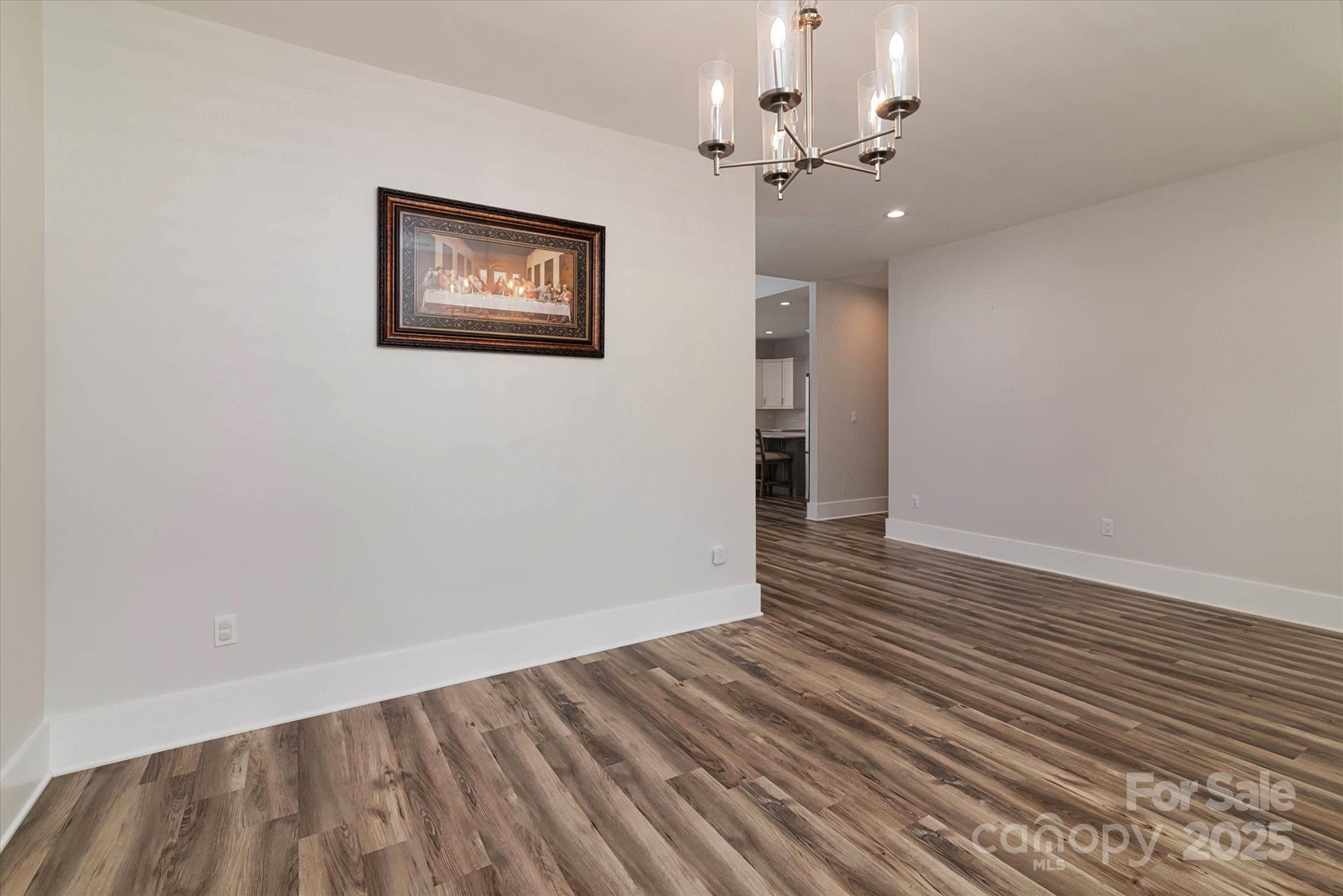 5345 Christopher Road Iron Station, NC 28080 - Photo 8 of 48 an empty room with wooden floor and windows