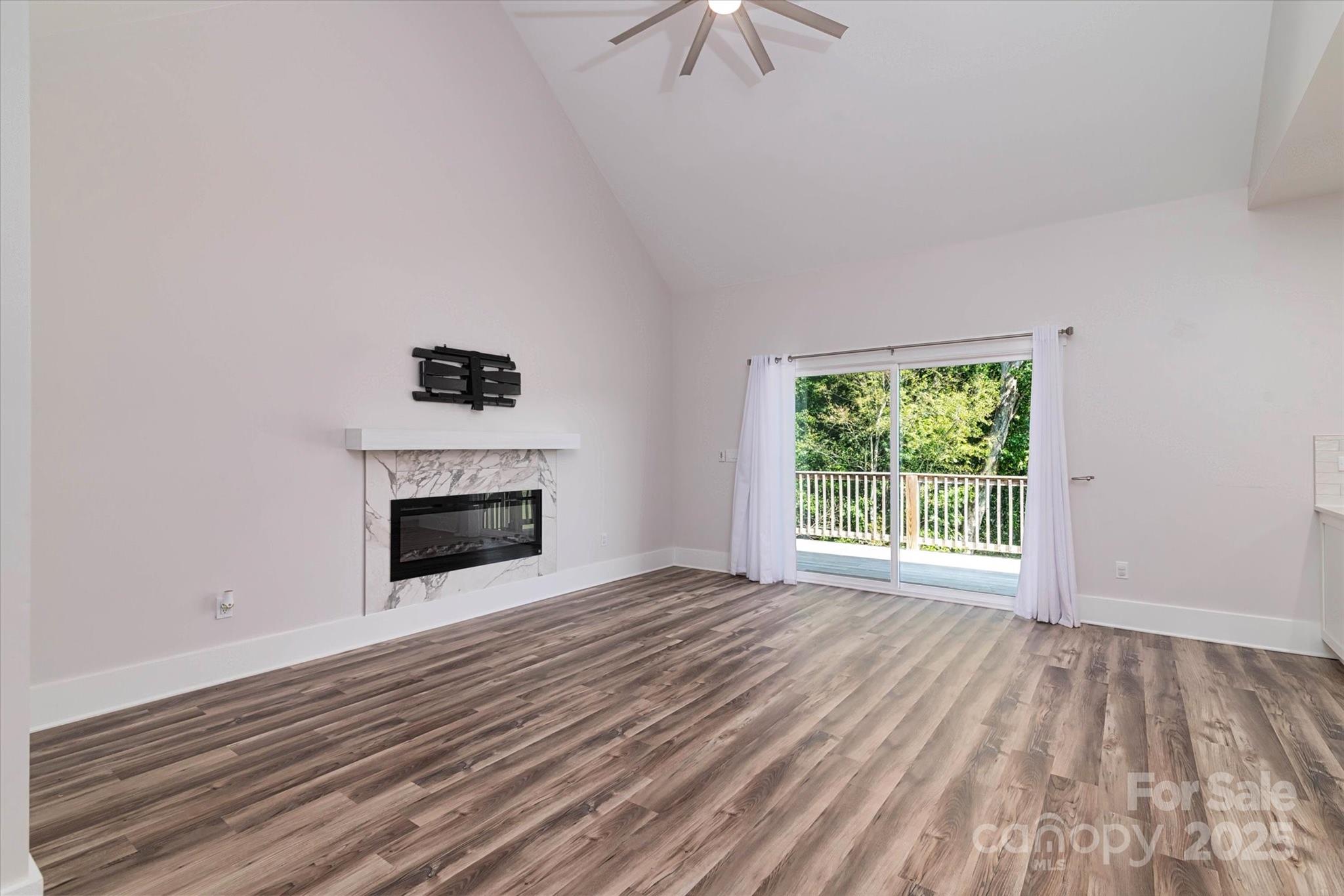 5345 Christopher Road Iron Station, NC 28080 - Photo 10 of 48 a view of empty room with a fireplace and wooden floor
