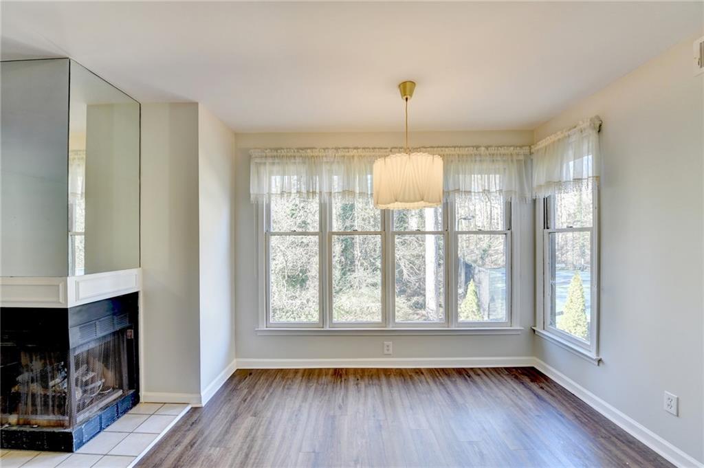 911 Garden Court, Unit 911 Atlanta, GA 30328 - Photo 12 of 41 a view of empty room with wooden floor and fan