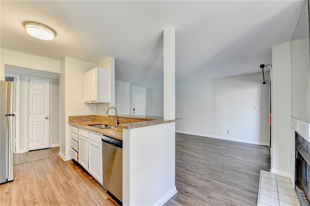 911 Garden Court, Unit 911 Atlanta, GA 30328 - Photo 14 of 41 a kitchen that has a sink and a stove in it