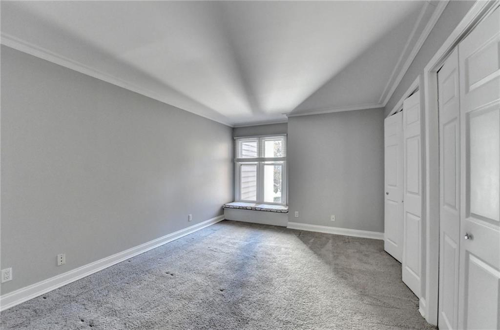 911 Garden Court, Unit 911 Atlanta, GA 30328 - Photo 21 of 41 an empty room with windows