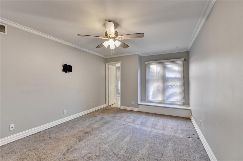 911 Garden Court, Unit 911 Atlanta, GA 30328 - Photo 28 of 41 an empty room with chandelier fan and windows