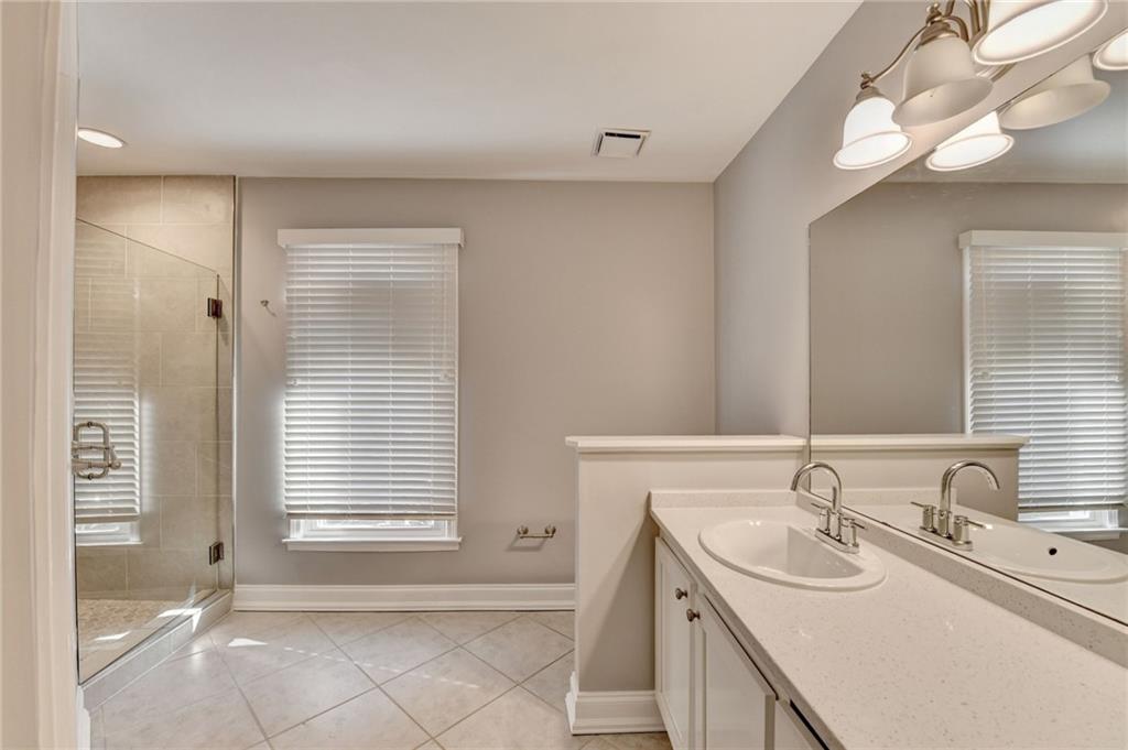 911 Garden Court, Unit 911 Atlanta, GA 30328 - Photo 30 of 41 a bathroom with a sink and a mirror