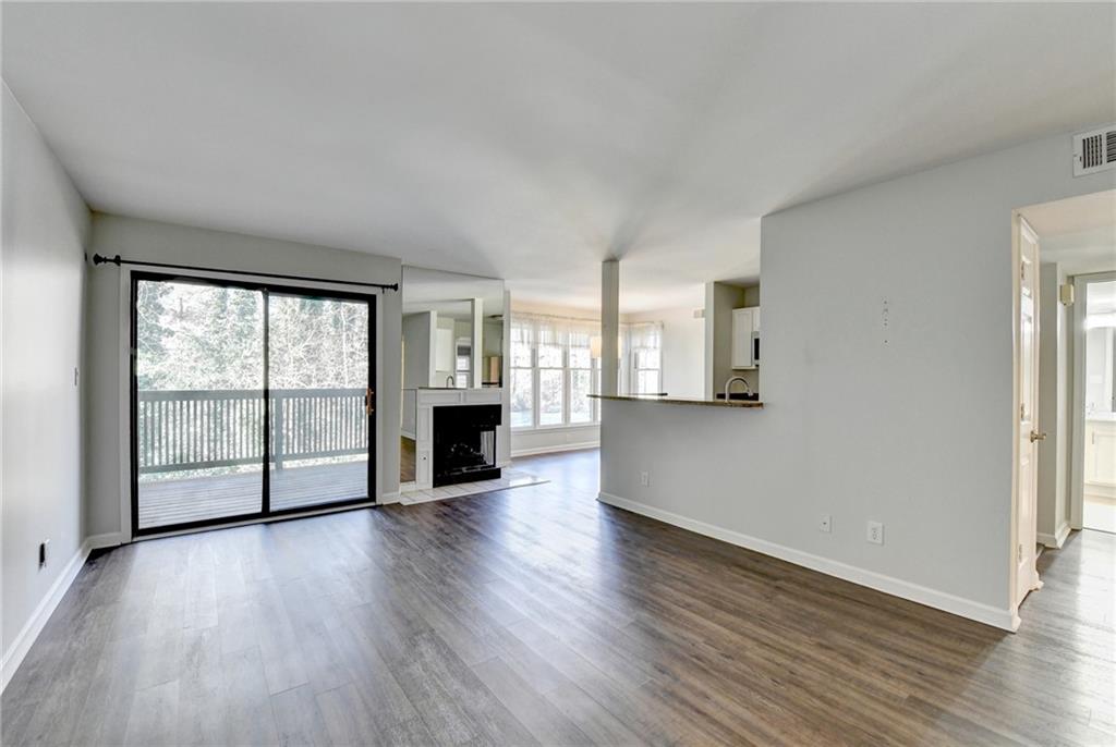 911 Garden Court, Unit 911 Atlanta, GA 30328 - Photo 3 of 41 a view of an empty room with wooden floor and a window