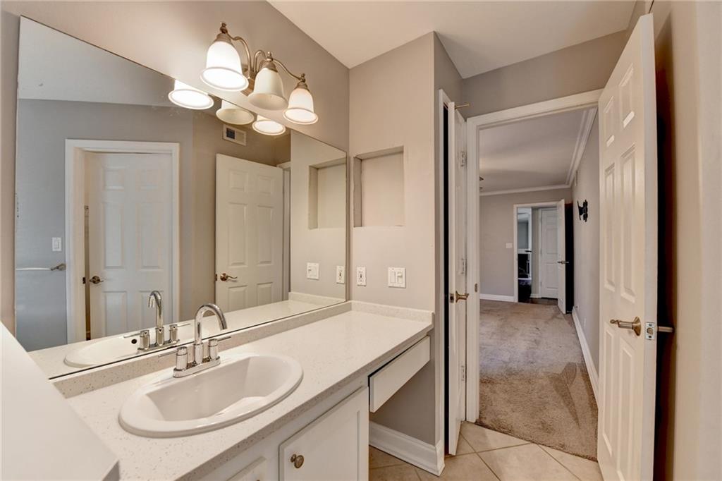 911 Garden Court, Unit 911 Atlanta, GA 30328 - Photo 32 of 41 a bathroom with a sink a light fixture and a mirror