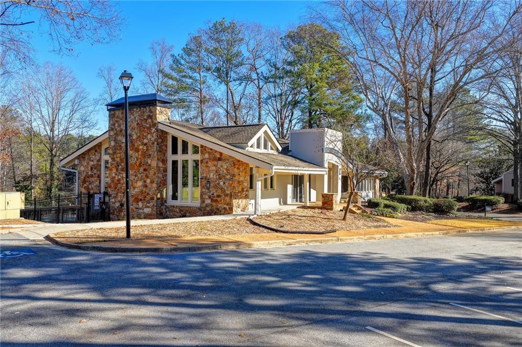 911 Garden Court, Unit 911 Atlanta, GA 30328 - Photo 35 of 41 a view of a white house with large trees and wooden fence