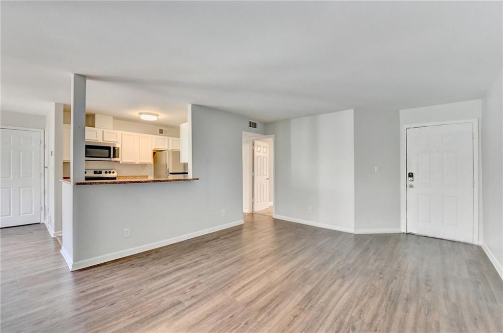 911 Garden Court, Unit 911 Atlanta, GA 30328 - Photo 7 of 41 a view of kitchen with wooden floor and electronic appliances