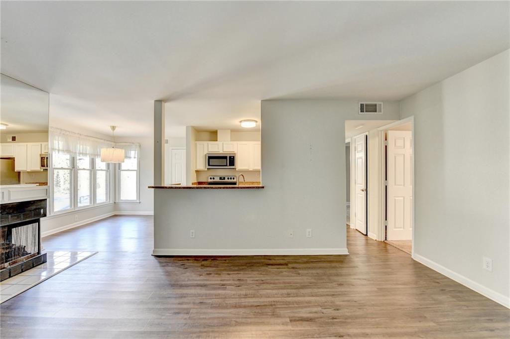 911 Garden Court, Unit 911 Atlanta, GA 30328 - Photo 8 of 41 a view of kitchen with furniture and wooden floor