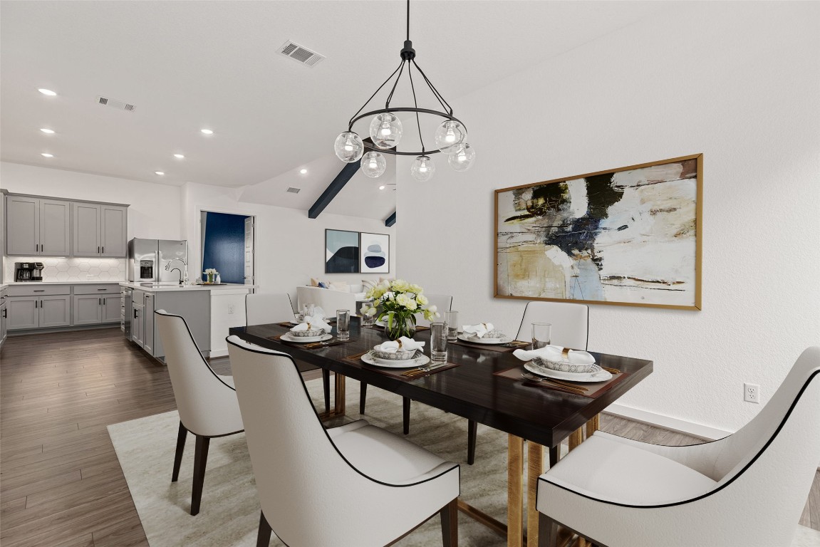 The sleek, modern chandelier adds just the right amount of drama without overwhelming the room.
*virtually staged*