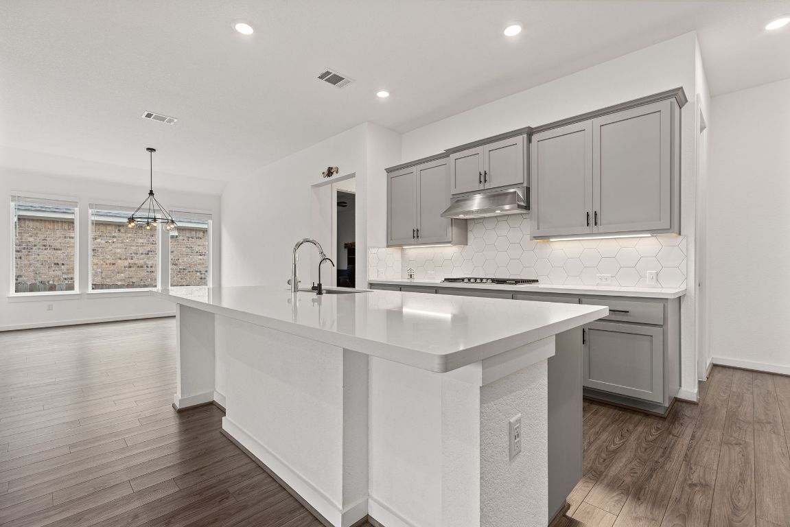 317 Independence Drive Kyle, TX 78640 - Photo 17 of 40 What really makes this kitchen special is how it flows. Whether you’re cooking a big meal or just grabbing a snack, it’s designed to keep everyone connected. The open concept means you can chat with guests in the dining area or watch a movie in the family room without missing a beat.