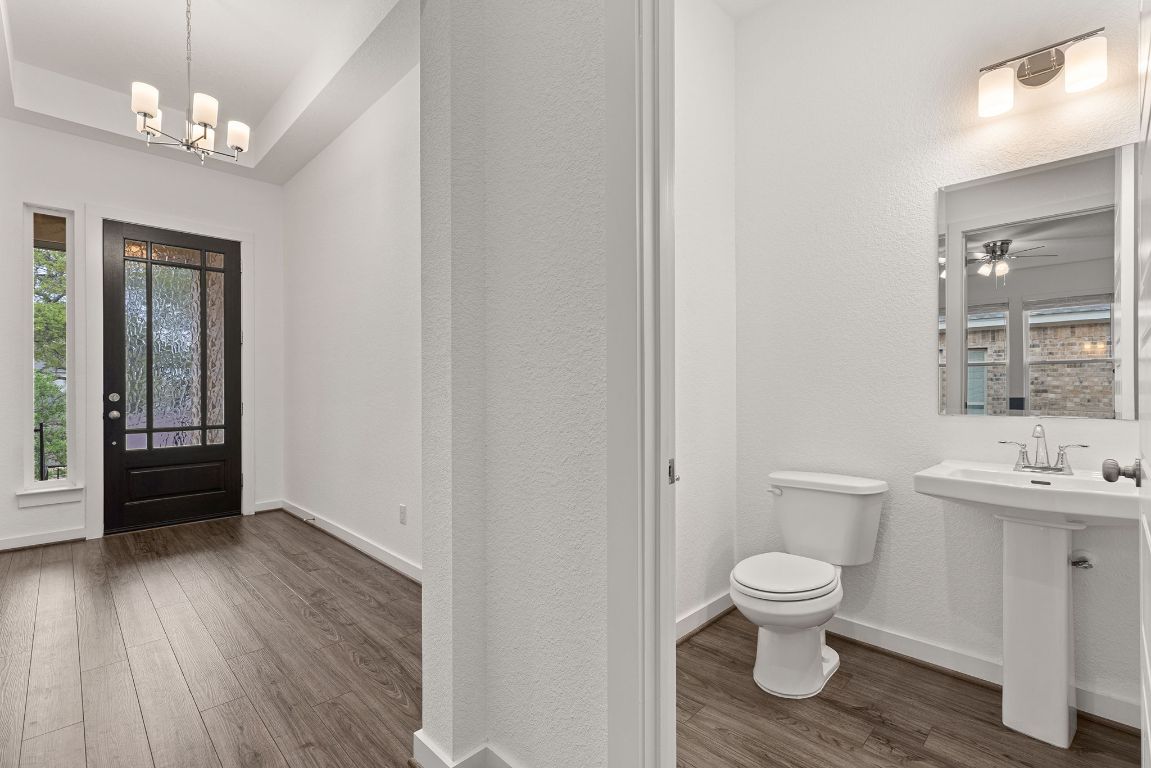 317 Independence Drive Kyle, TX 78640 - Photo 19 of 40 The Half - Bathroom is perfect for guests, offering a quick, easy stop without having to venture deeper into the house.