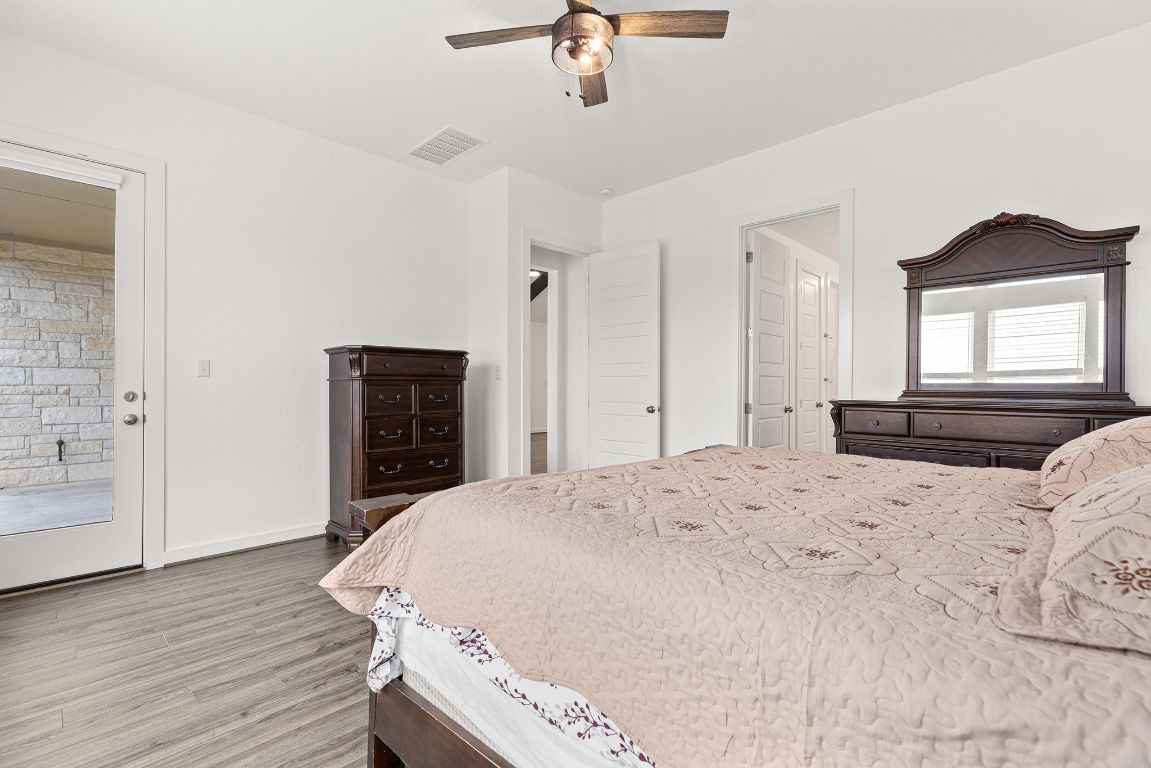317 Independence Drive Kyle, TX 78640 - Photo 22 of 40 The layout is smart, too. There’s a dedicated spot for a dresser without disrupting the flow, and the stylish ceiling fan overhead adds a modern touch while keeping the space cool.