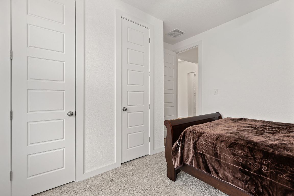 317 Independence Drive Kyle, TX 78640 - Photo 29 of 40 The ceiling fans add a practical touch, keeping the rooms comfortable year-round. There’s enough room to include a bed, dresser, and even a small desk if you’re looking to create a study or hobby area.