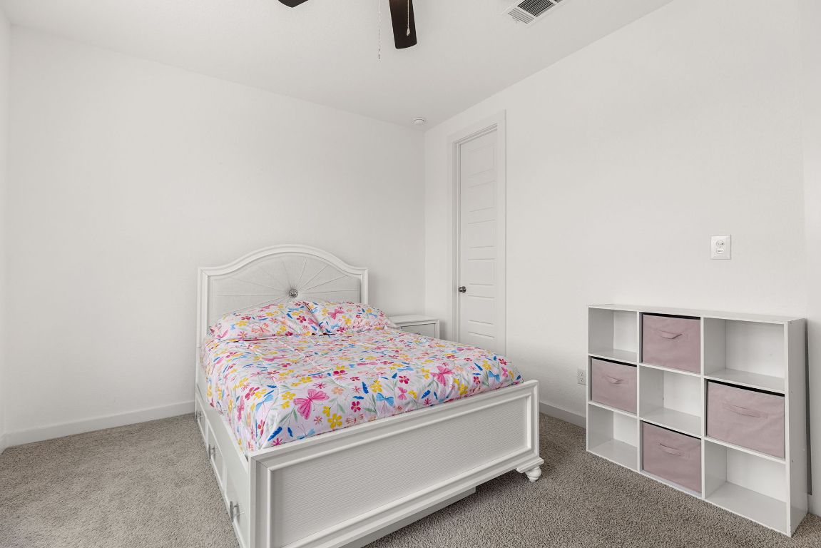 317 Independence Drive Kyle, TX 78640 - Photo 31 of 40 The ceiling fans add a practical touch, keeping the rooms comfortable year-round. There’s enough room to include a bed, dresser, and even a small desk if you’re looking to create a study or hobby area.
