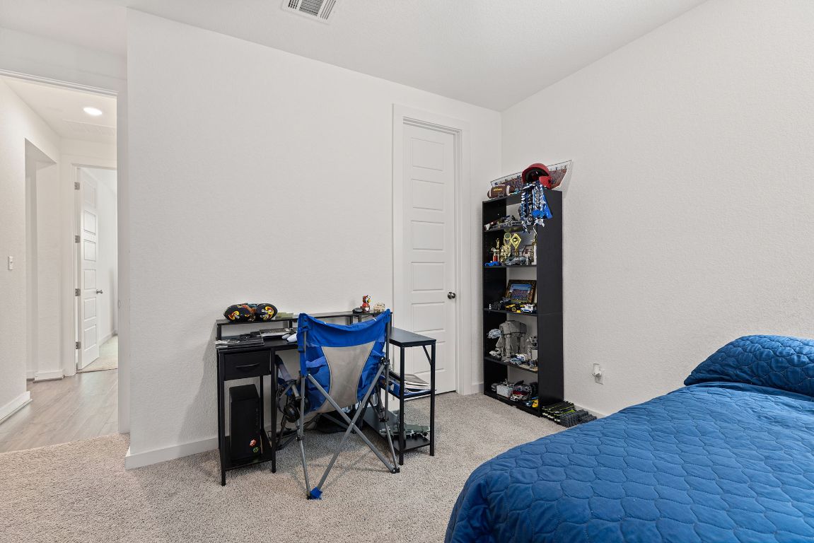 317 Independence Drive Kyle, TX 78640 - Photo 33 of 40 The ceiling fans add a practical touch, keeping the rooms comfortable year-round. There’s enough room to include a bed, dresser, and even a small desk if you’re looking to create a study or hobby area.