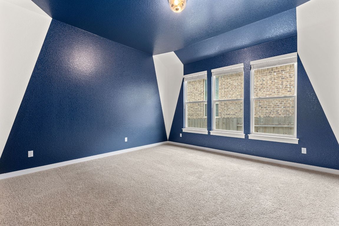 317 Independence Drive Kyle, TX 78640 - Photo 37 of 40 The rich, deep blue walls give it a cinematic feel, making it the ideal spot to set up your projector or big screen.