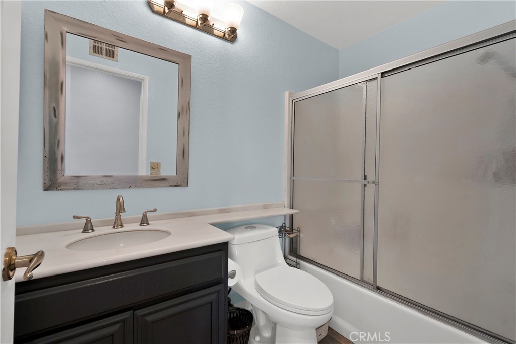 3350 May Court Riverside, CA 92503 - Photo 16 of 55 a bathroom with a granite countertop sink toilet and shower
