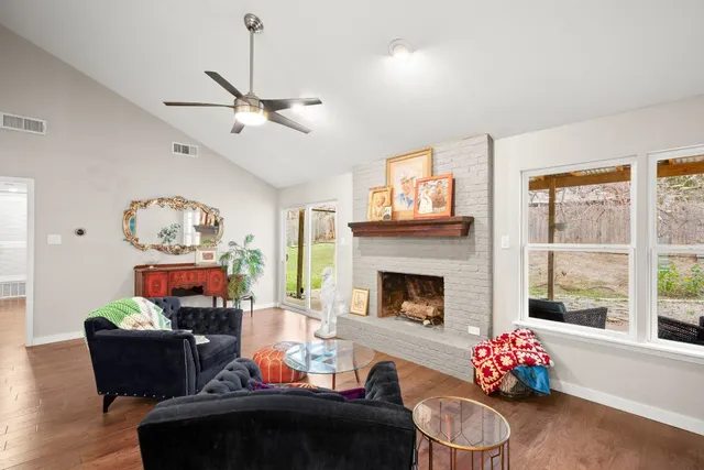 a living room with furniture and a fireplace
