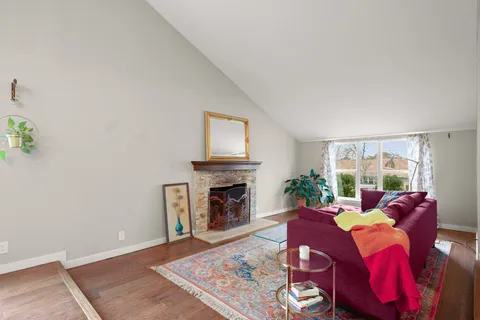 a living room with furniture fireplace and window