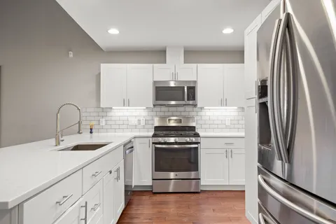 a kitchen with a sink stove and refrigerator