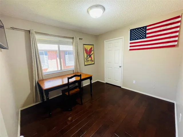 a room with wooden floor and windows
