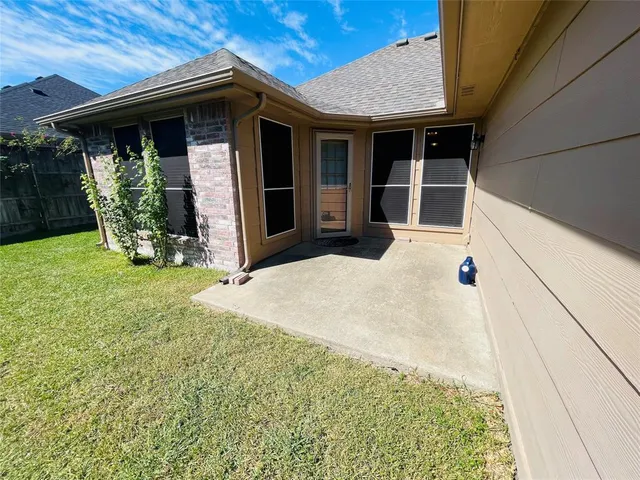 a view of a backyard of the house