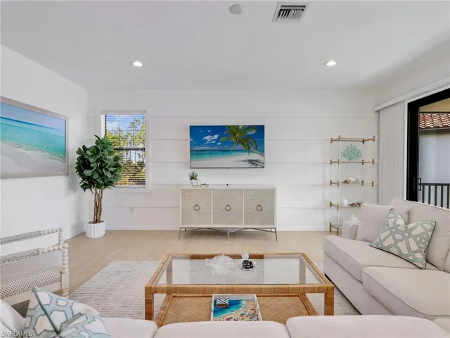 a living room with furniture and flowers