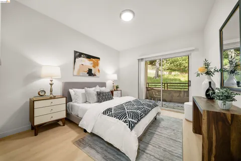 a bedroom with bed and a large window