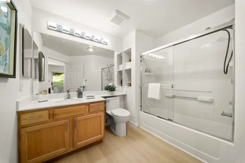 a bathroom with a double vanity sink toilet and shower