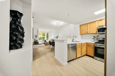 a kitchen with white cabinets and appliances