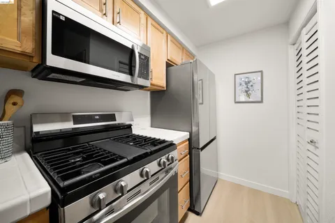 a stove top oven sitting inside of a kitchen