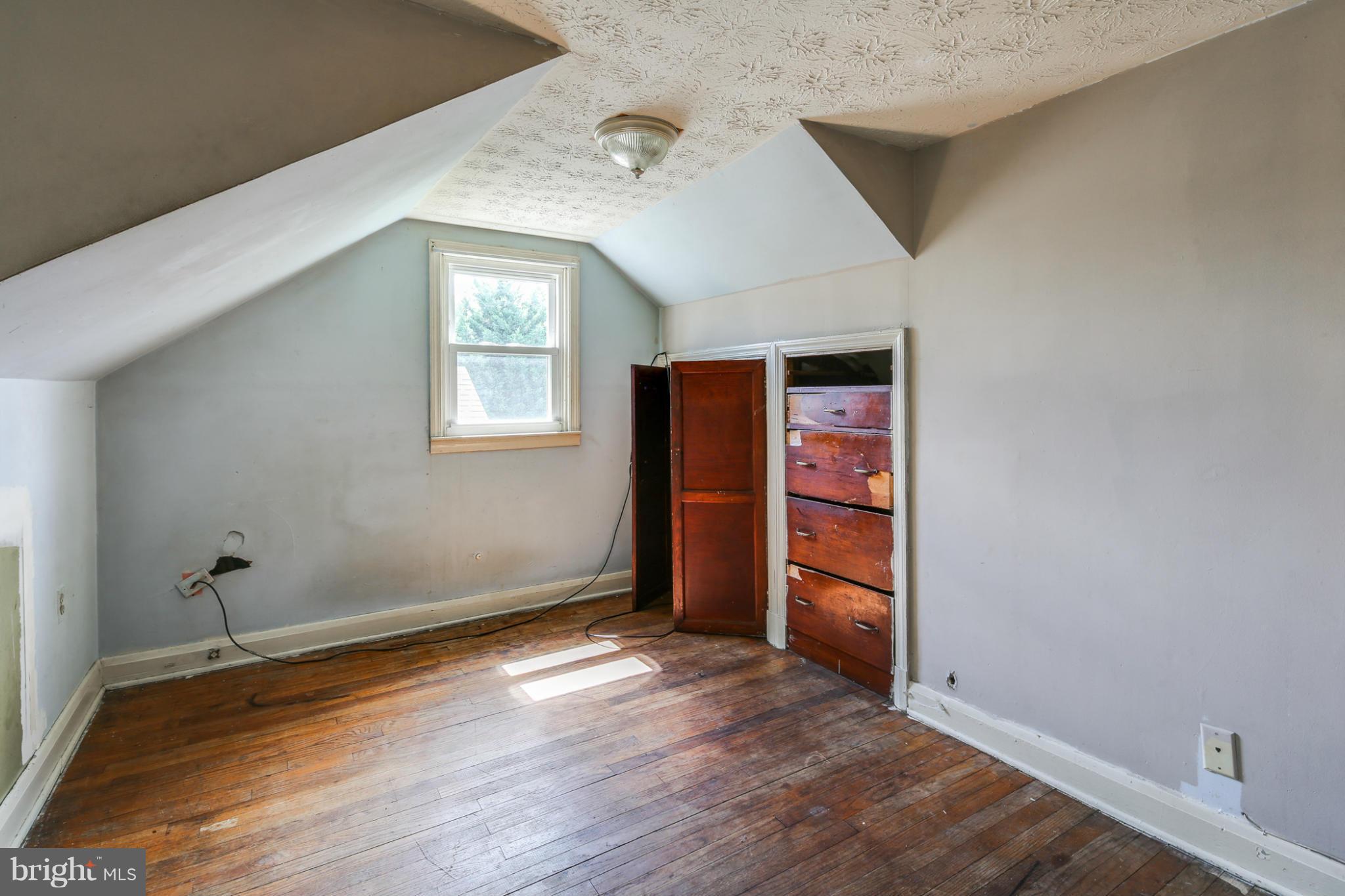 4117 Old Washington Road Baltimore, MD 21227 - Photo 14 of 27 an empty room with wooden floor closet and windows