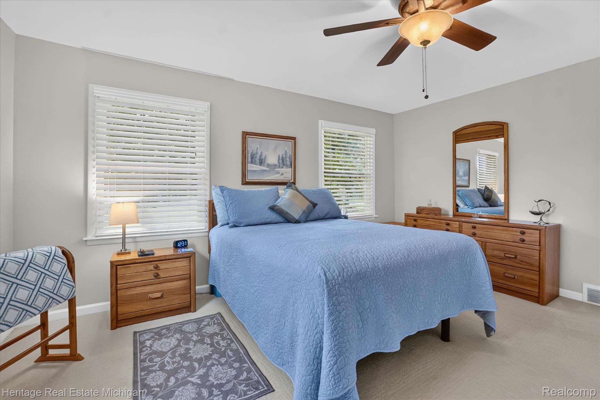14038 North Hogan Road Linden, MI 48451 - Photo 25 of 53 Bedroom featuring two windows with white blinds, neutral wall paint, and light-toned carpeting