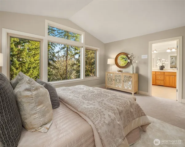 a spacious bedroom with a bed and a large window