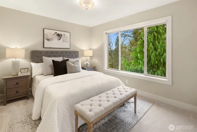 a bedroom with a bed and a large window