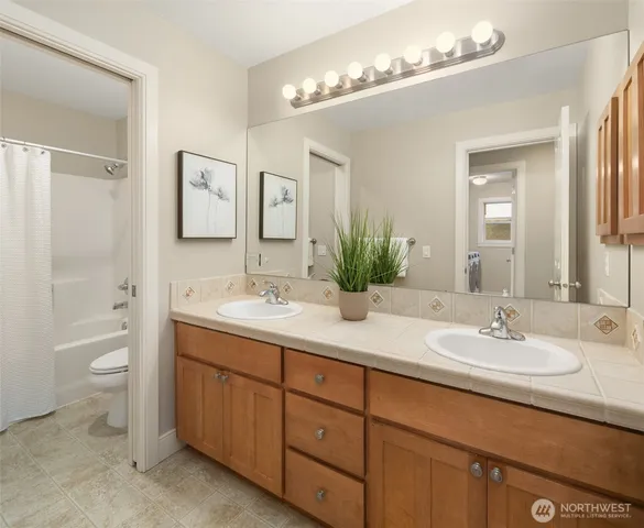 a bathroom with a sink double vanity and a mirror