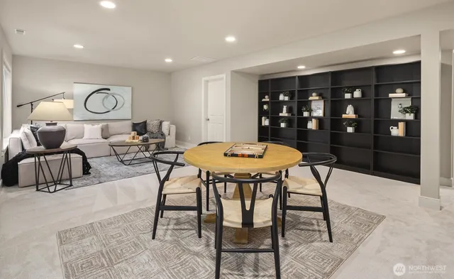 a view of a dining room and livingroom with furniture a rug and a chandelier